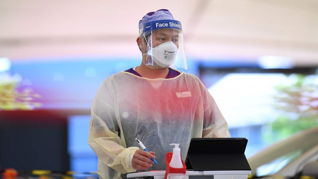 Healthcare worker Brandon Nguyen is seen working at a drive-through Covid19 testing facility in Melbourne, Friday, October 8, 2021.