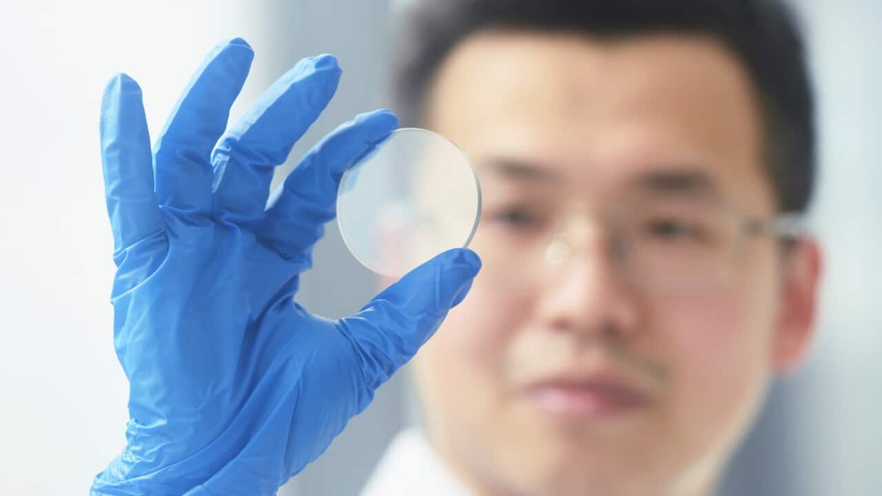 A worker examines a gallium oxide wafer at a Chinese research lab (Getty)