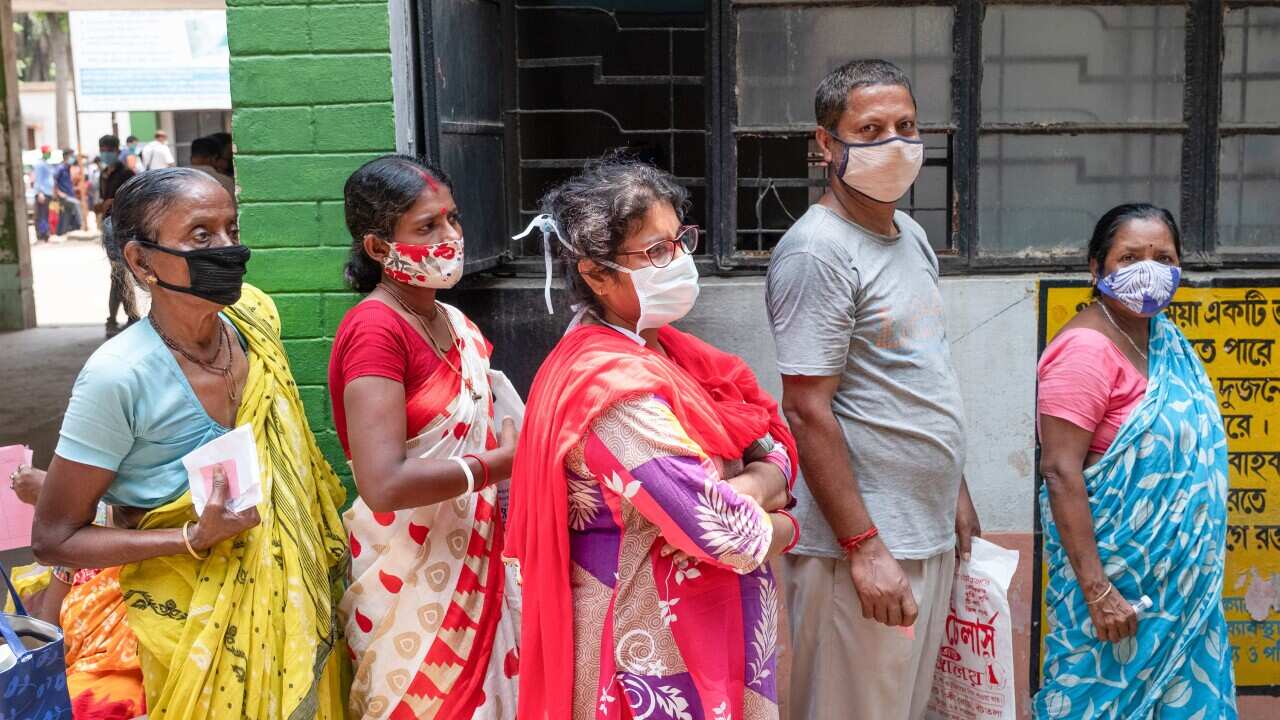 People stand in a long queue with no social distance before getting a Covid19 test