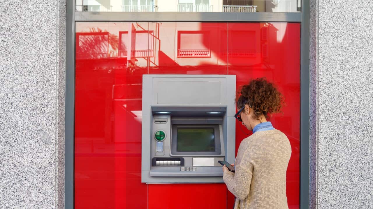 Latin woman using ATM