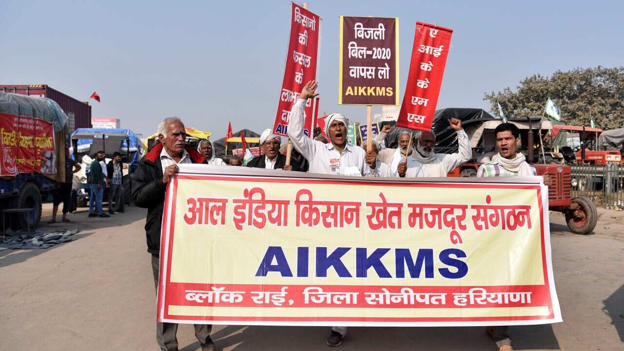 Farmers shout slogans during a protest against the farm laws,