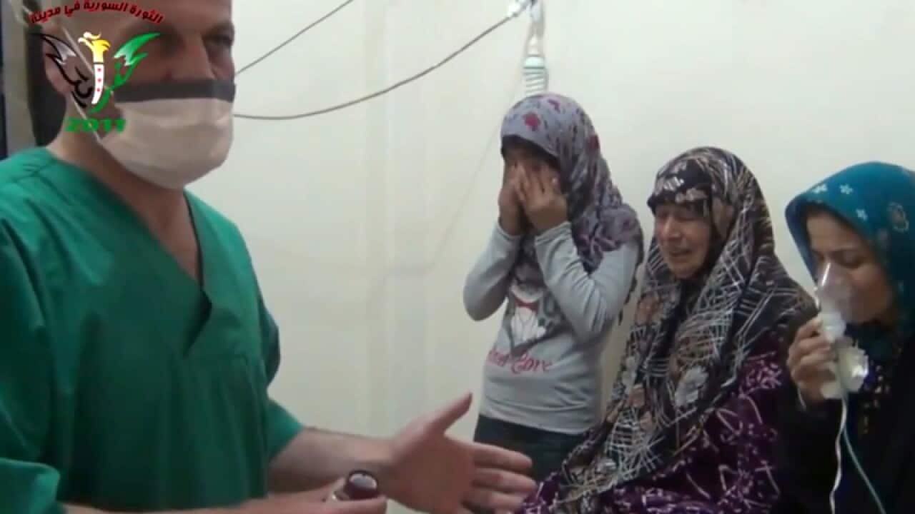 Women are treated by a medic after a chemical attack in Syria