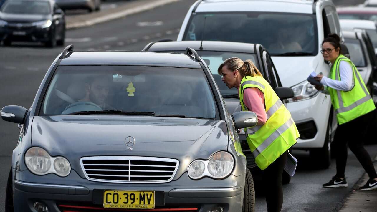 Lines of cars are seen snaking around the block as people line up for COVID-19 testing at the Crossroads Hotel testing centre in Sydney.