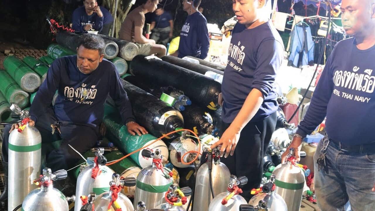 Thai Navy personnel preparing oxygen tanks for the ongoing rescue operations.