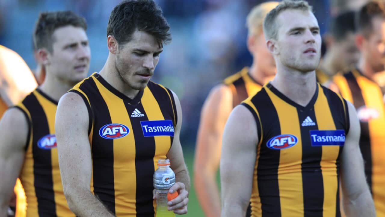 Isaac Smith (second from left) and other Hawks team members