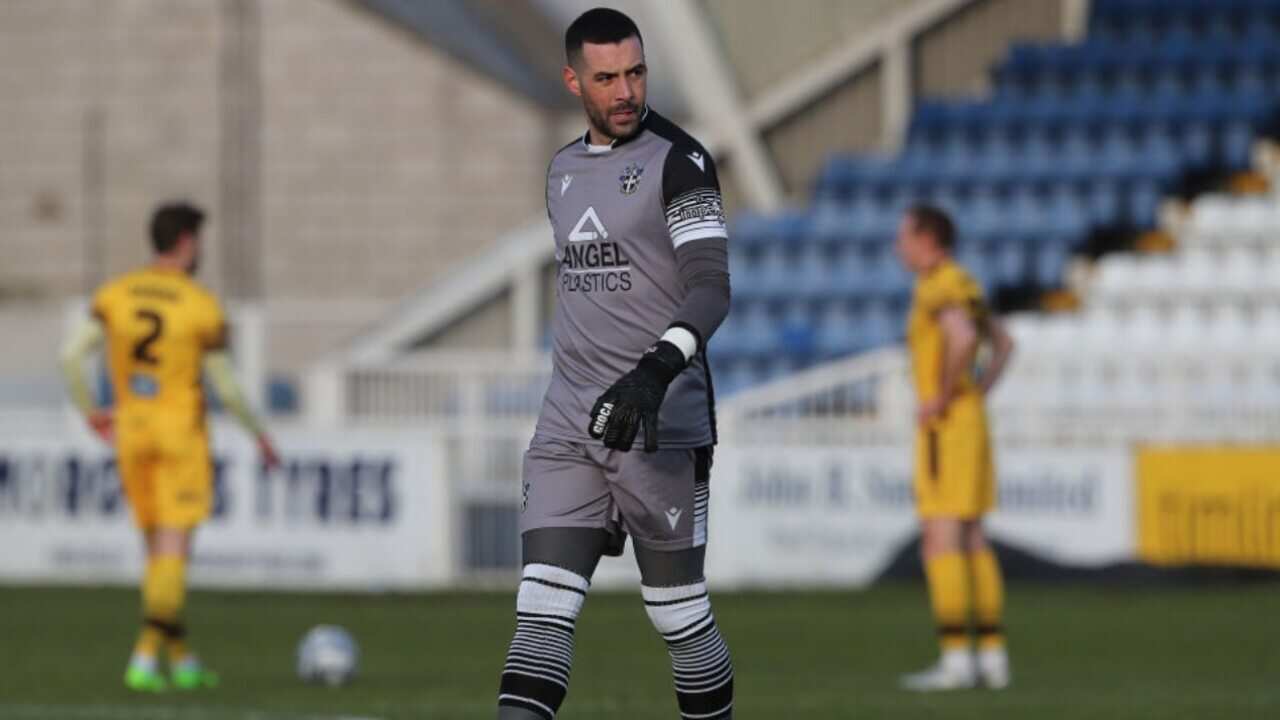 Dean Bouzanis in action for Sutton United