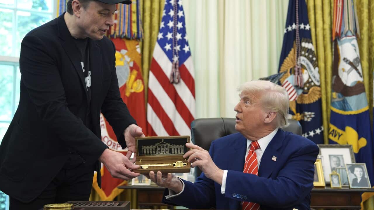 US President Donald Trump handing billionaire Elon Musk a symbolic key.