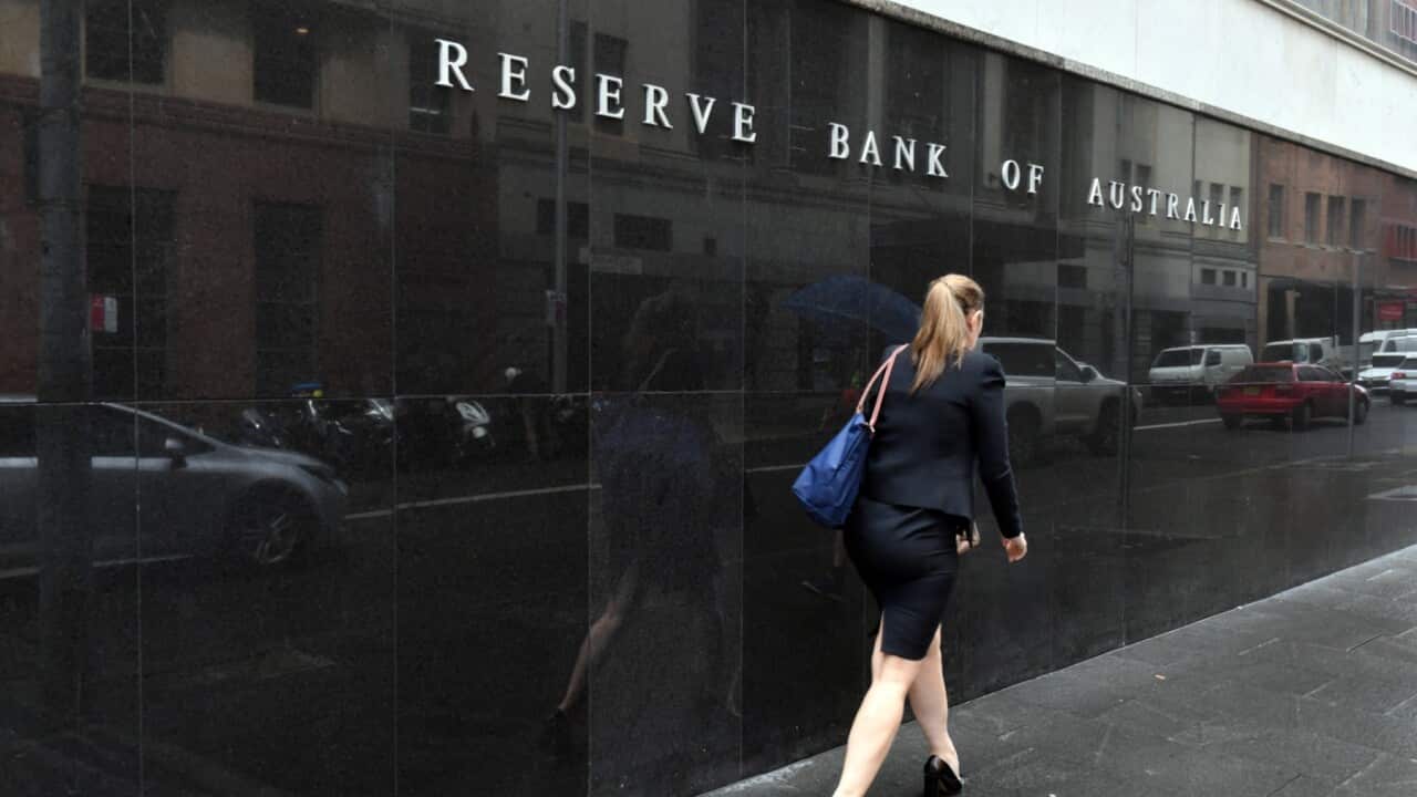 A pedestrian walks past the Reserve Back of Australia head office in Sydney, Tuesday, December 7, 2021.