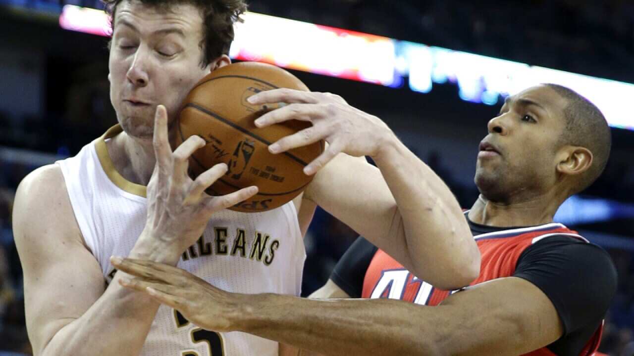 New Orleans' Omer Asik (L) and Atlanta's Al Horford