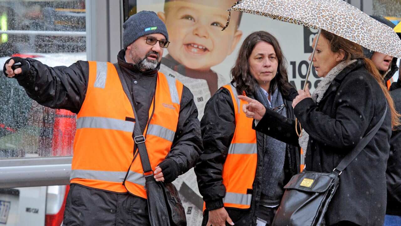 Yarra tram officials direct commuters in Melbourne