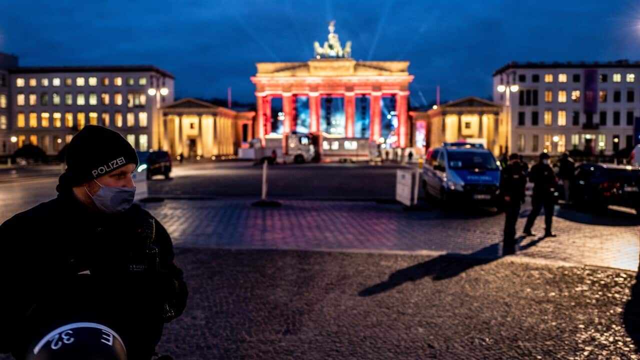 Police on patrol at Berlin's Brandenburg gate, where no crowds will be allowed for New Year's Eve