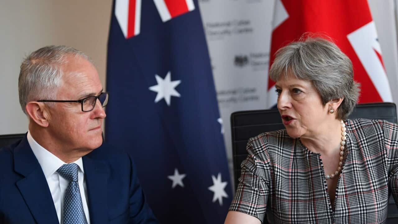Australian Prime Minister Malcolm Turnbull (left) and British Prime Minister Theresa May speak during an Intelligence Partners meeting
