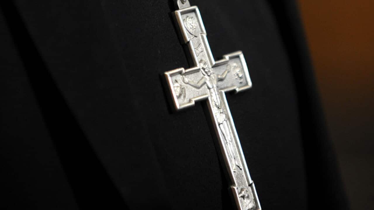 A crucifix being worn by a priest