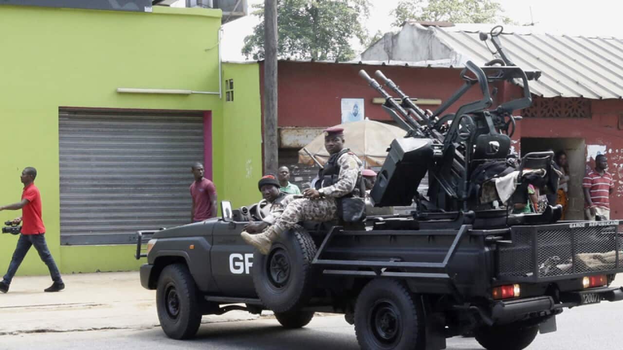 Rebel soldiers in an armed vehicle block a road in Abidjan