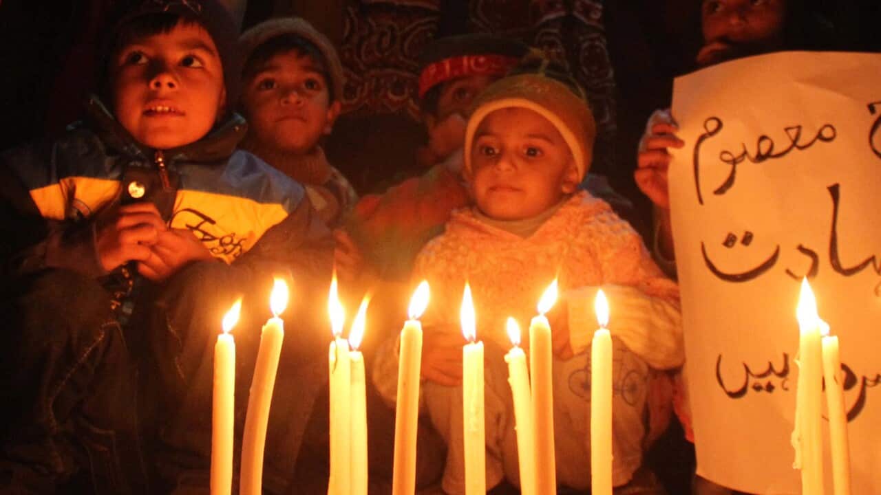 Supporters of Pakistan Tehrik-e-Insaf (PTI) light candles to pray for the victims who were killed in an attack at the Army run school in Peshawar