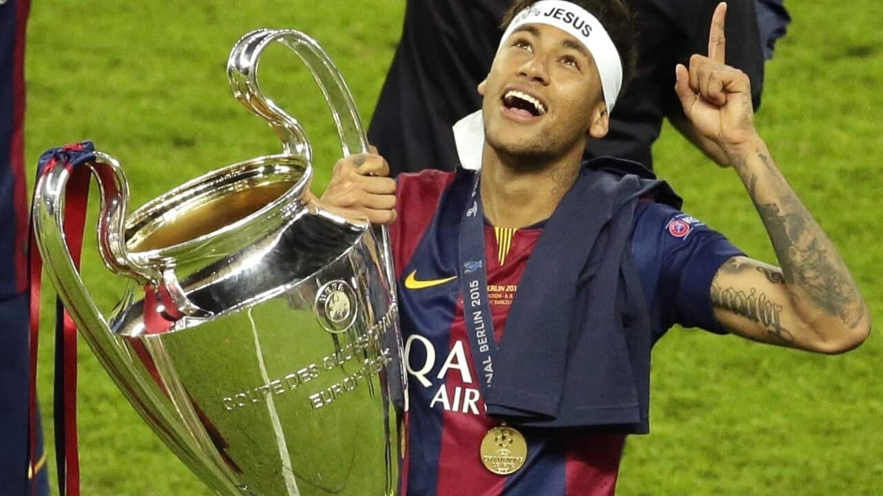 In this Saturday, June 6, 2015 file photo, Barcelona's Neymar celebrates with the trophy after the Champions League final soccer match