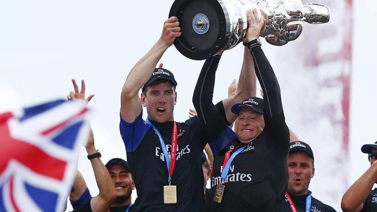 Peter Burling and Glenn Ashby hold the America's Cup trophy