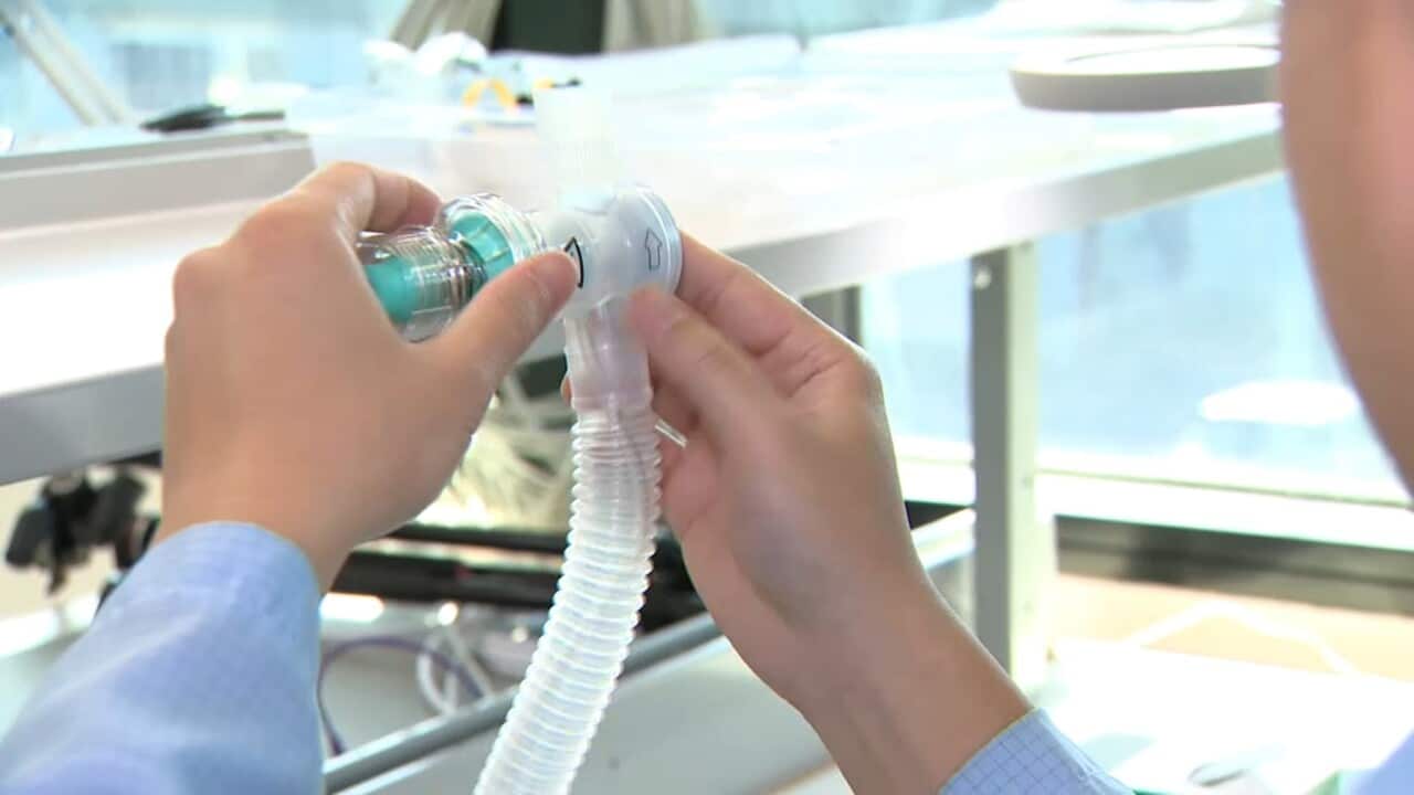 Worker makes a ventilator
