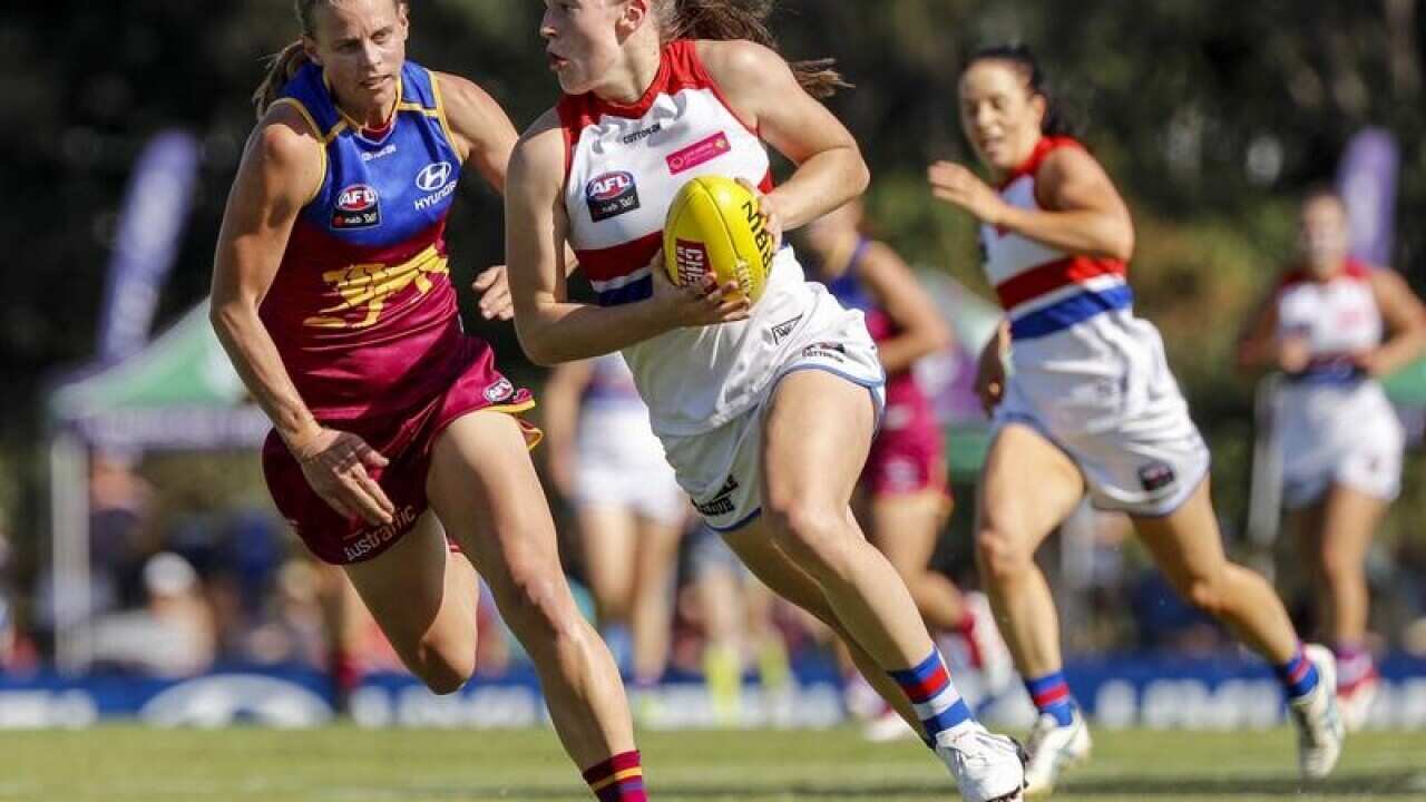Kate Lutkins (left) of the Lions chases down Isabel Huntington.