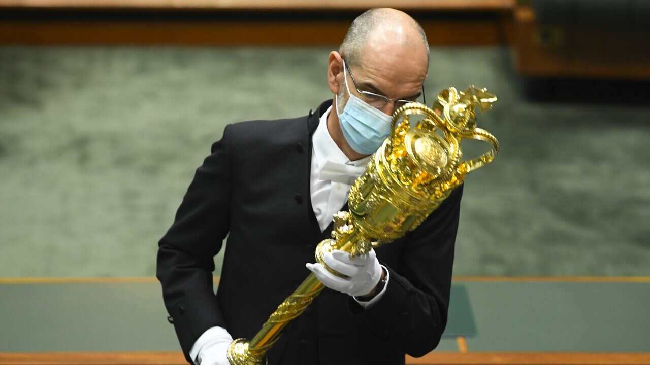 The Serjeant-at-Arms places the mace in position at the beginning of parliamentary sitting in the House of Representatives at Parliament House in Canberra.
