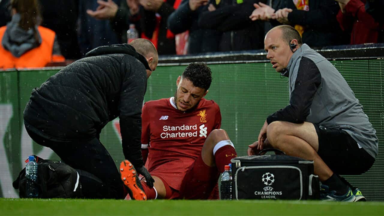 Alex Oxlade-Chamberlain reacts to an injury