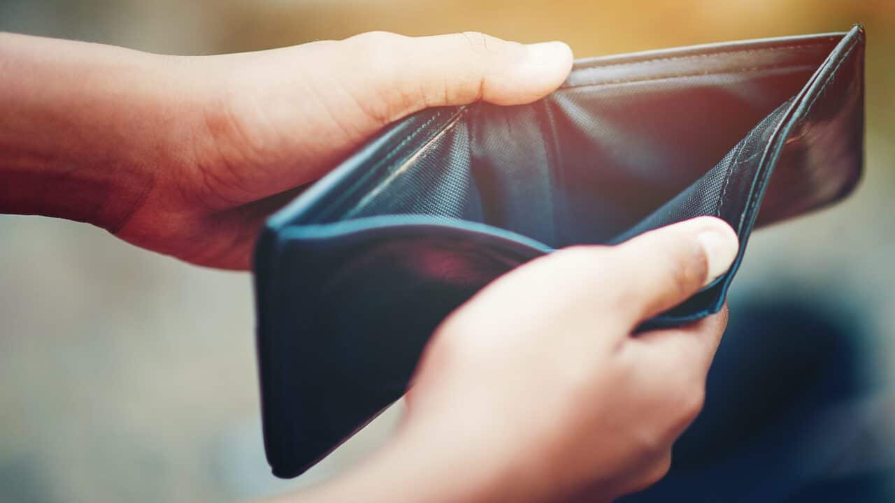 Close-up of person's hands holding open an empty wallet.