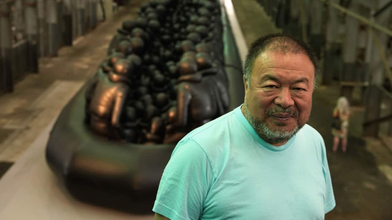 Ai Weiwei in front of his installation 'Law of the Journey'.