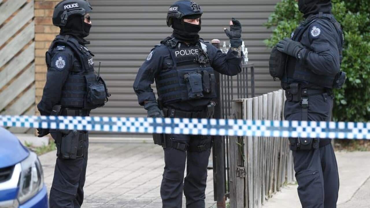Police are seen at one of the sites
