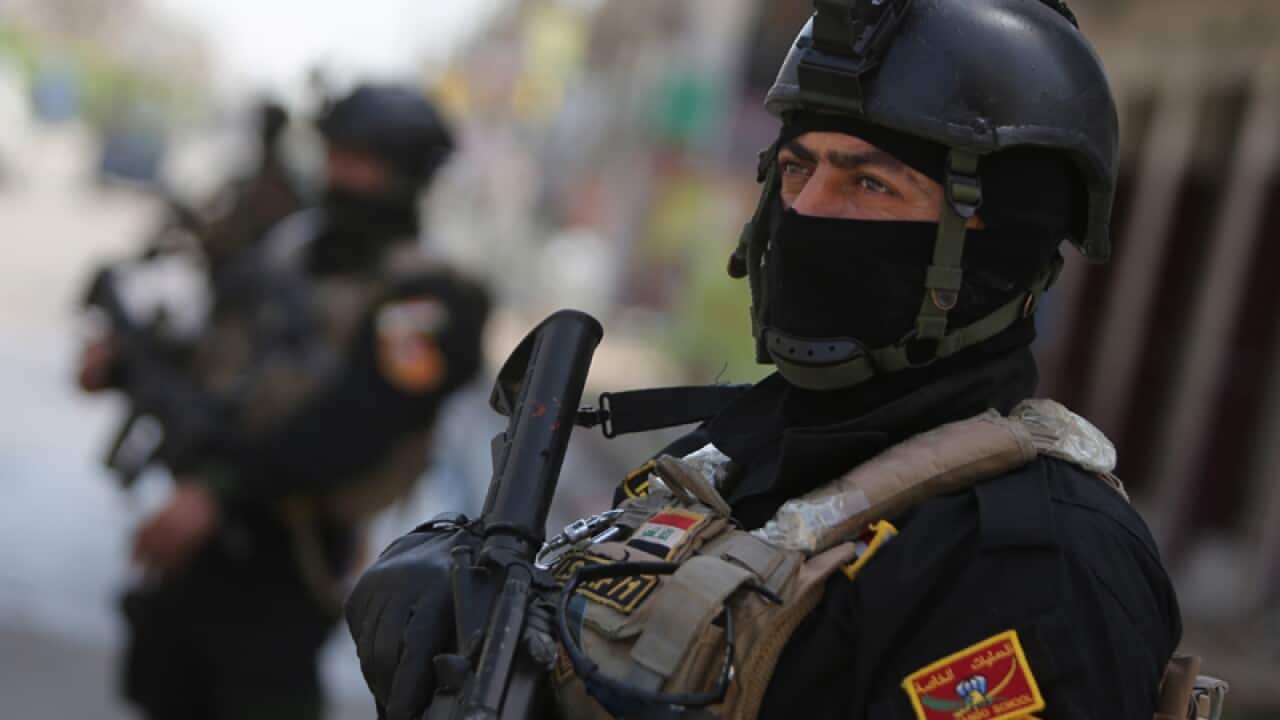 Members of Iraq's anti-terrorism force outside a polling station