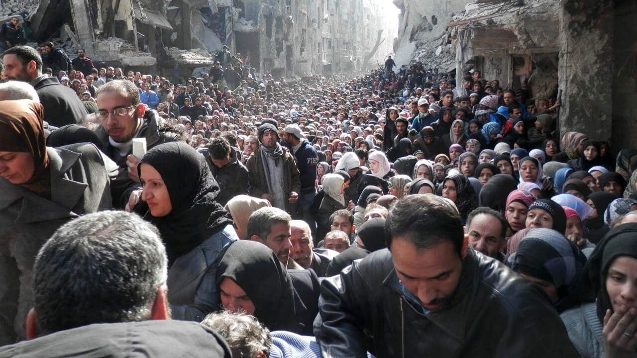 Residents of Syria's besieged Yarmuk Palestinian refugee camp, south of Damascus,