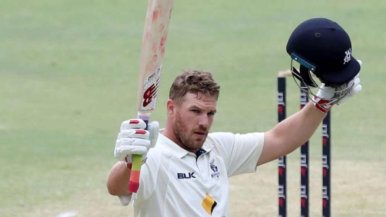 Aaron Finch of Victoria raises his bat during a match in Perth.