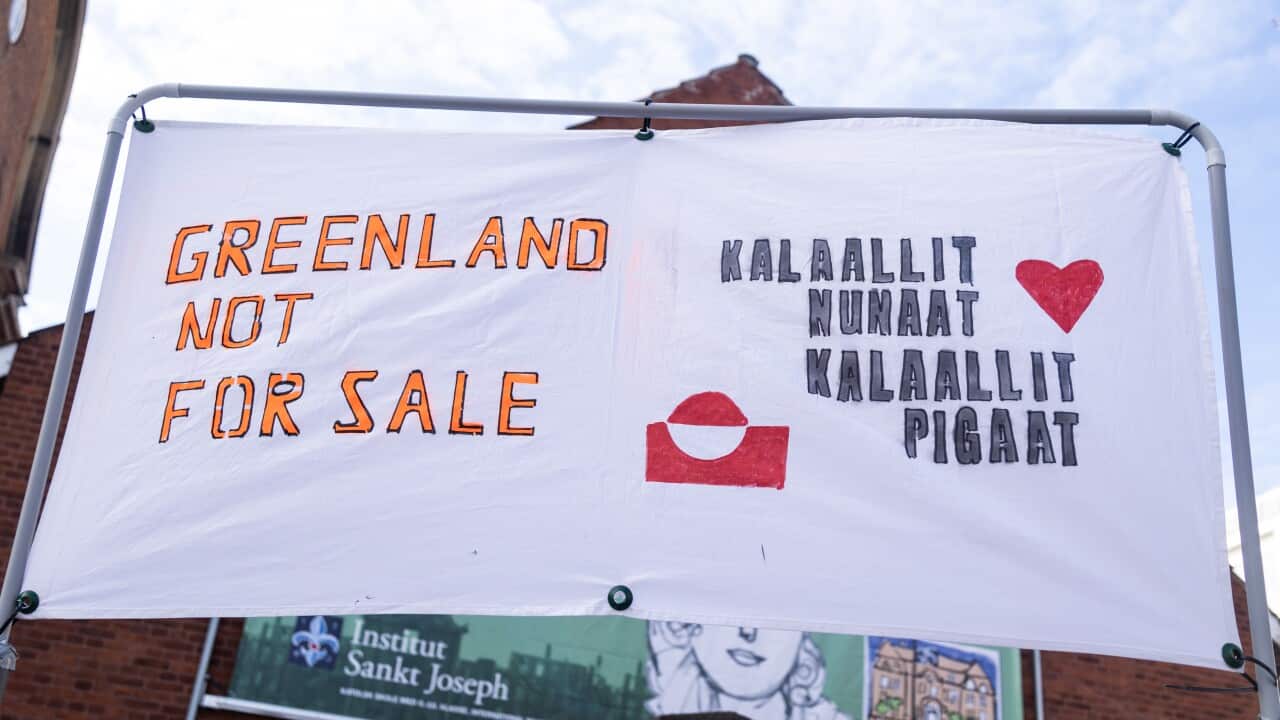 A banner saying "Greenland not for sale" and "