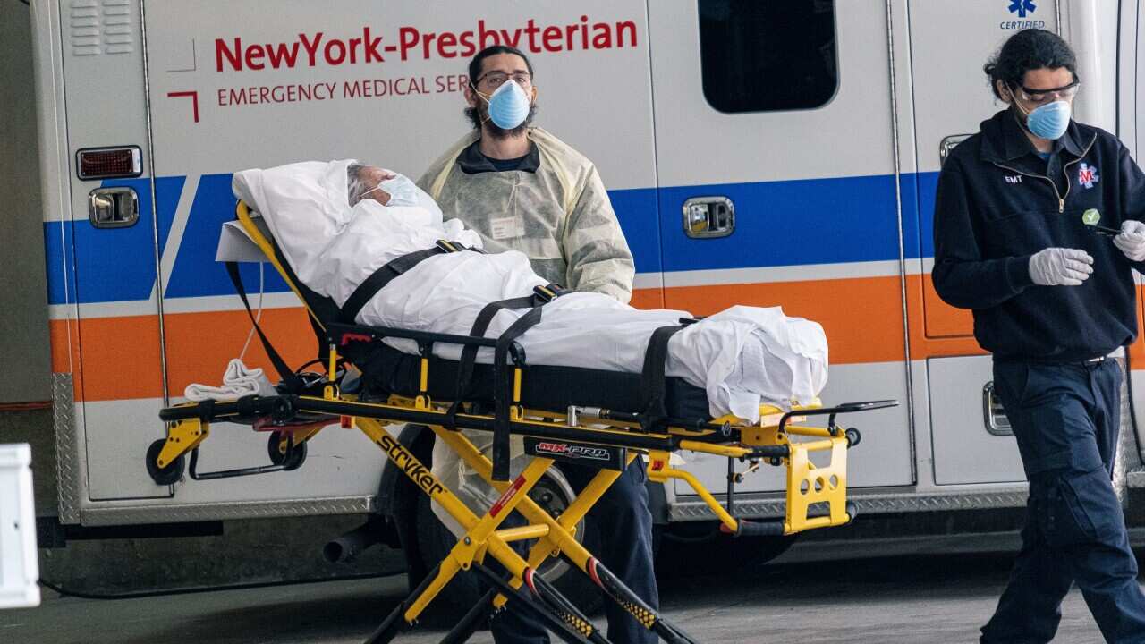 A COVID-19 patient is moved to an ambulance at a hospital in New York (AAP)