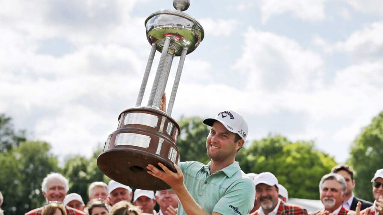 Chris Kirk lifts the trophy after winning the Colonial golf tournament
