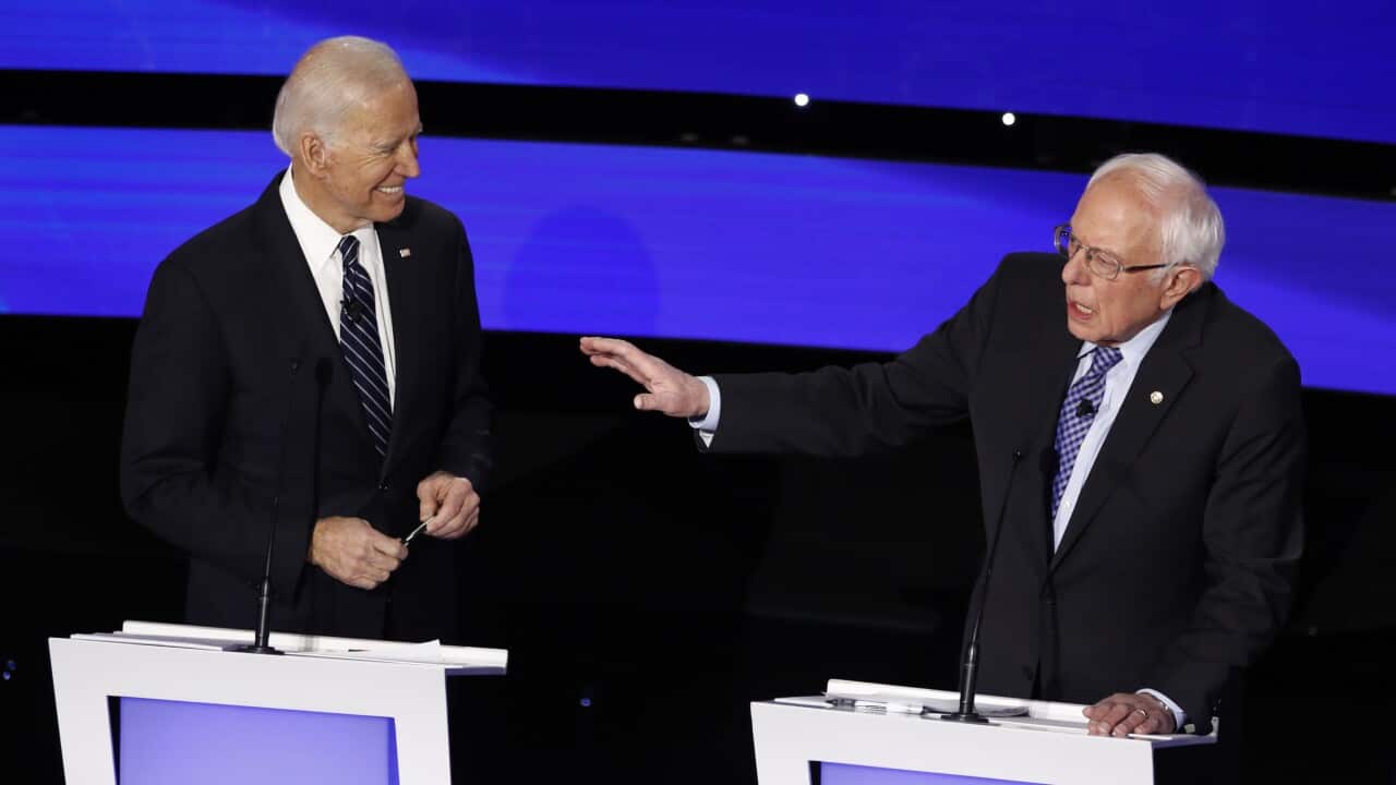 Democratic presidential candidate Bernie Sanders speaks as former Vice President Joe Biden looks on during the debate.