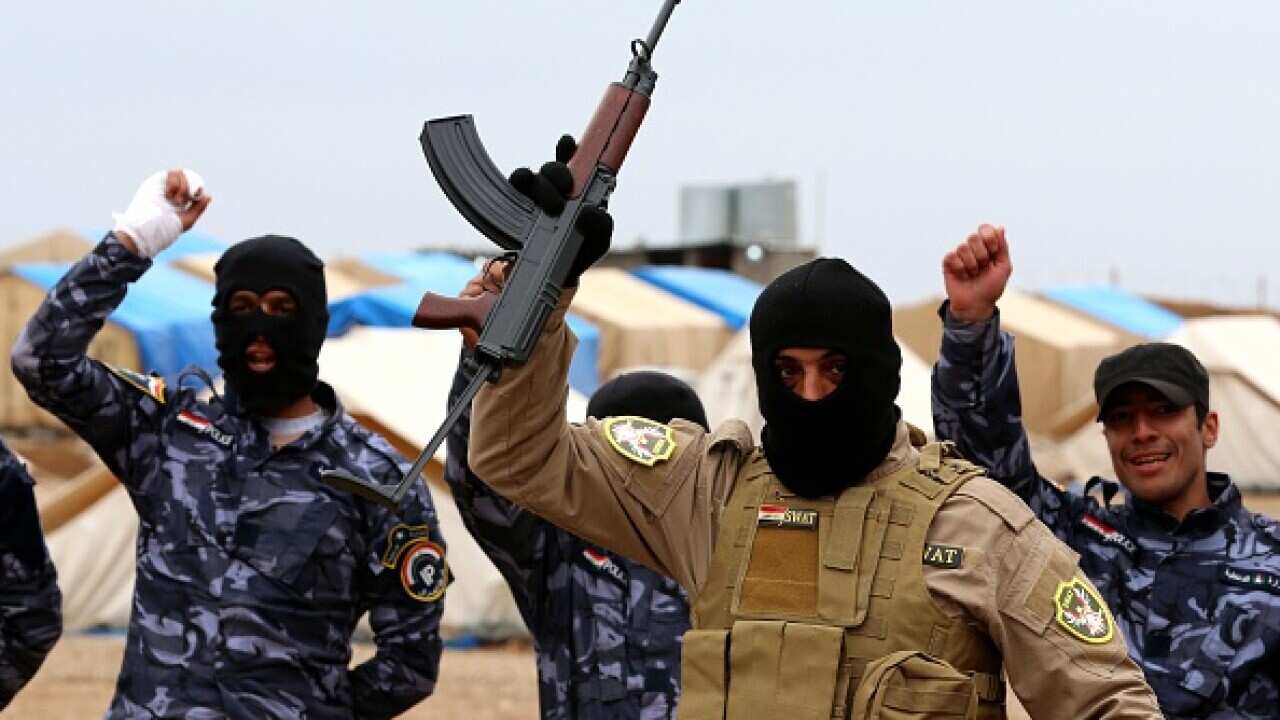 Iraqi special forces policemen cheer as they line up during a training session at a camp in the Bardarash district as they prepare to recapture the northern Iraqi city of Mosul (HAMED/AFP/Getty Images)
