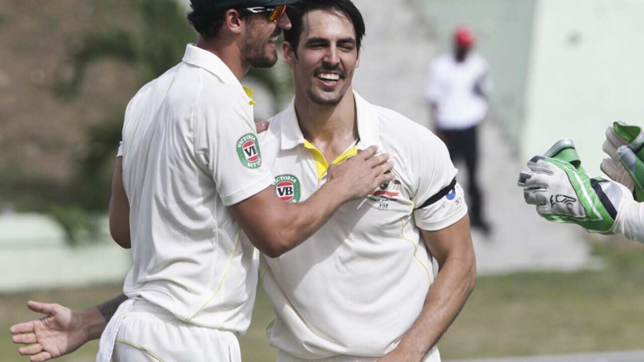 Australia's Mitchell Starc celebrates with teammates Mitchell Johnson