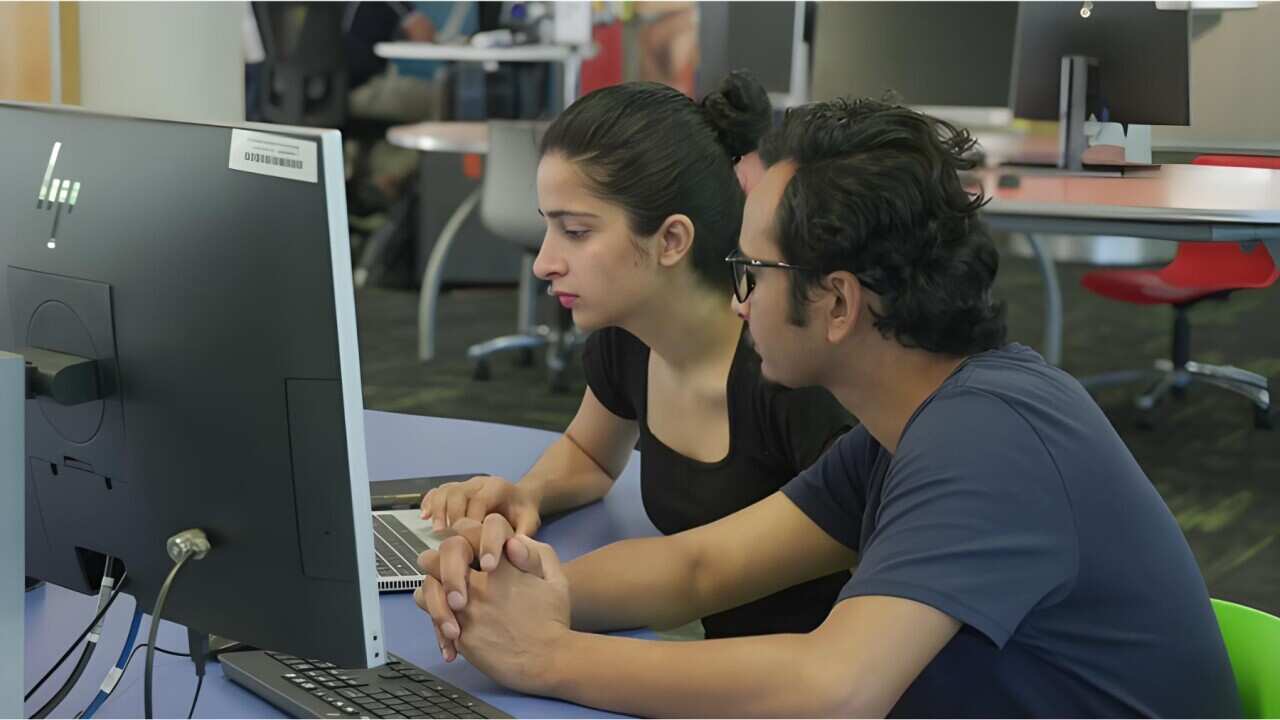 Madhu Regmi (L) and Yuvraj Pokhrel working at University (SBS).jpg