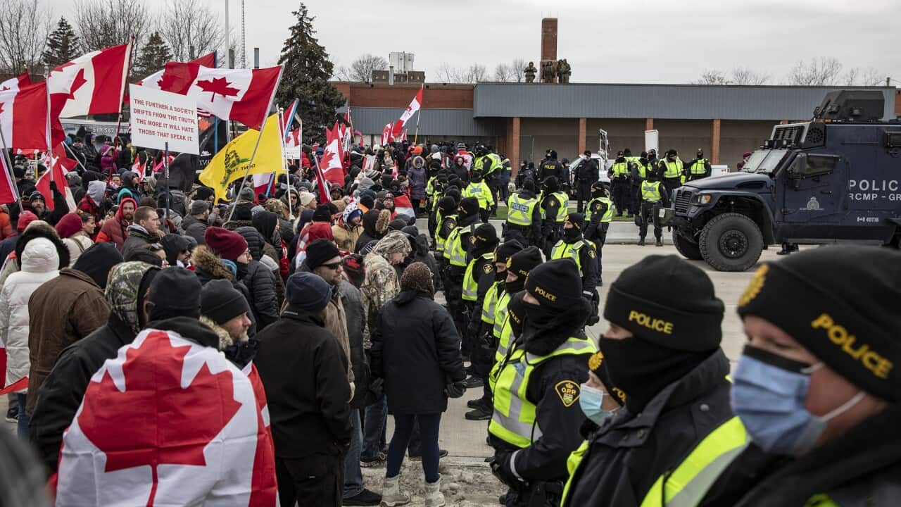 Police confront the protesters who arrive at the blockade of the Ambassador Bridge, Ontario.