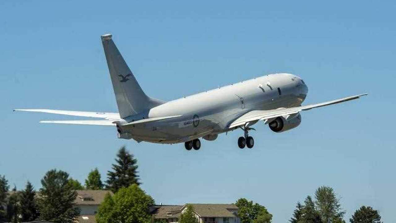 A white plane is taking off.