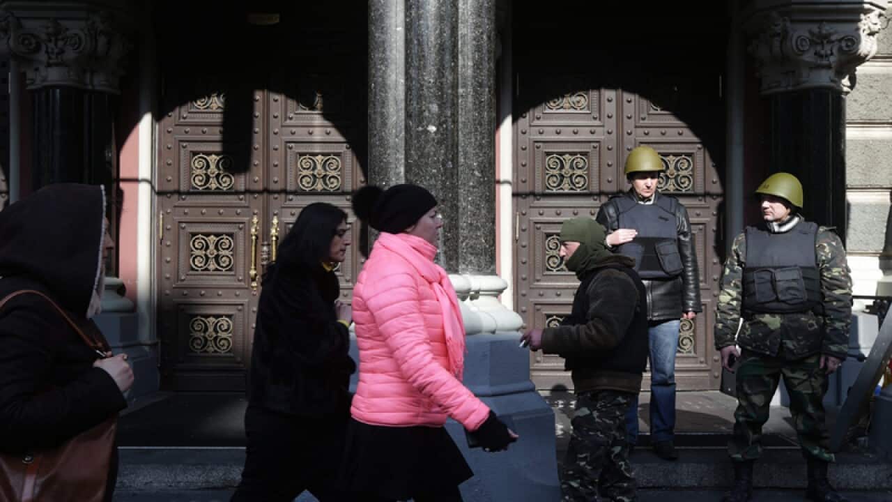 Anti-government protester guard the Ukrainian National bank building