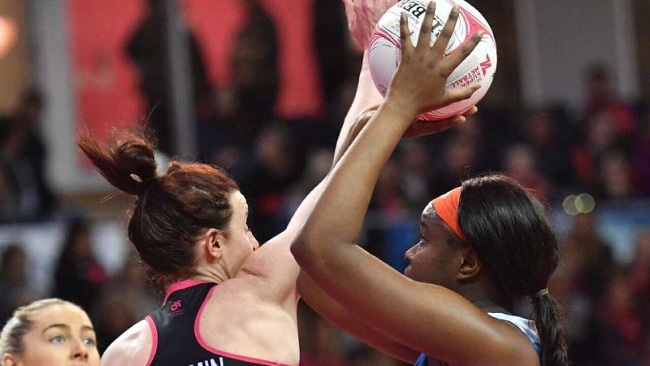 Sam Wallace of the Swifts (right) looks to shoot