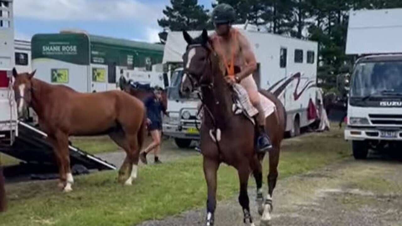A man wearing a mankini on a horse