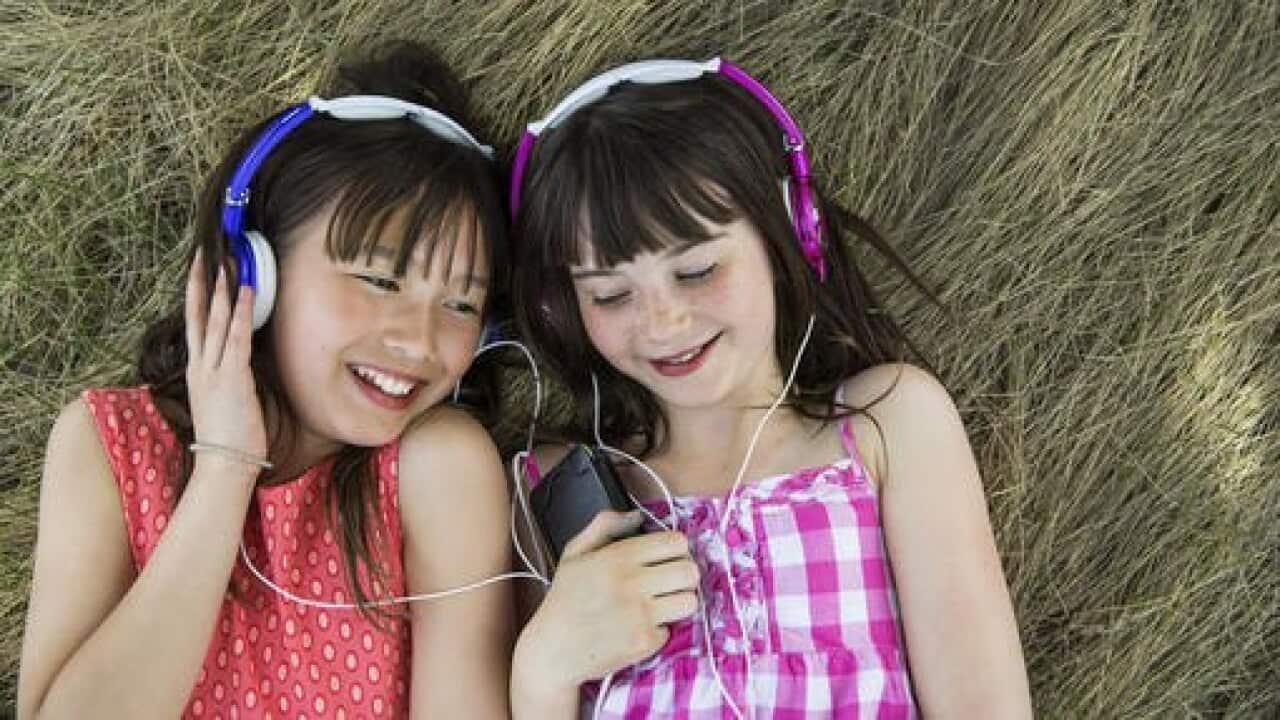 Girls lying down listening to headphones