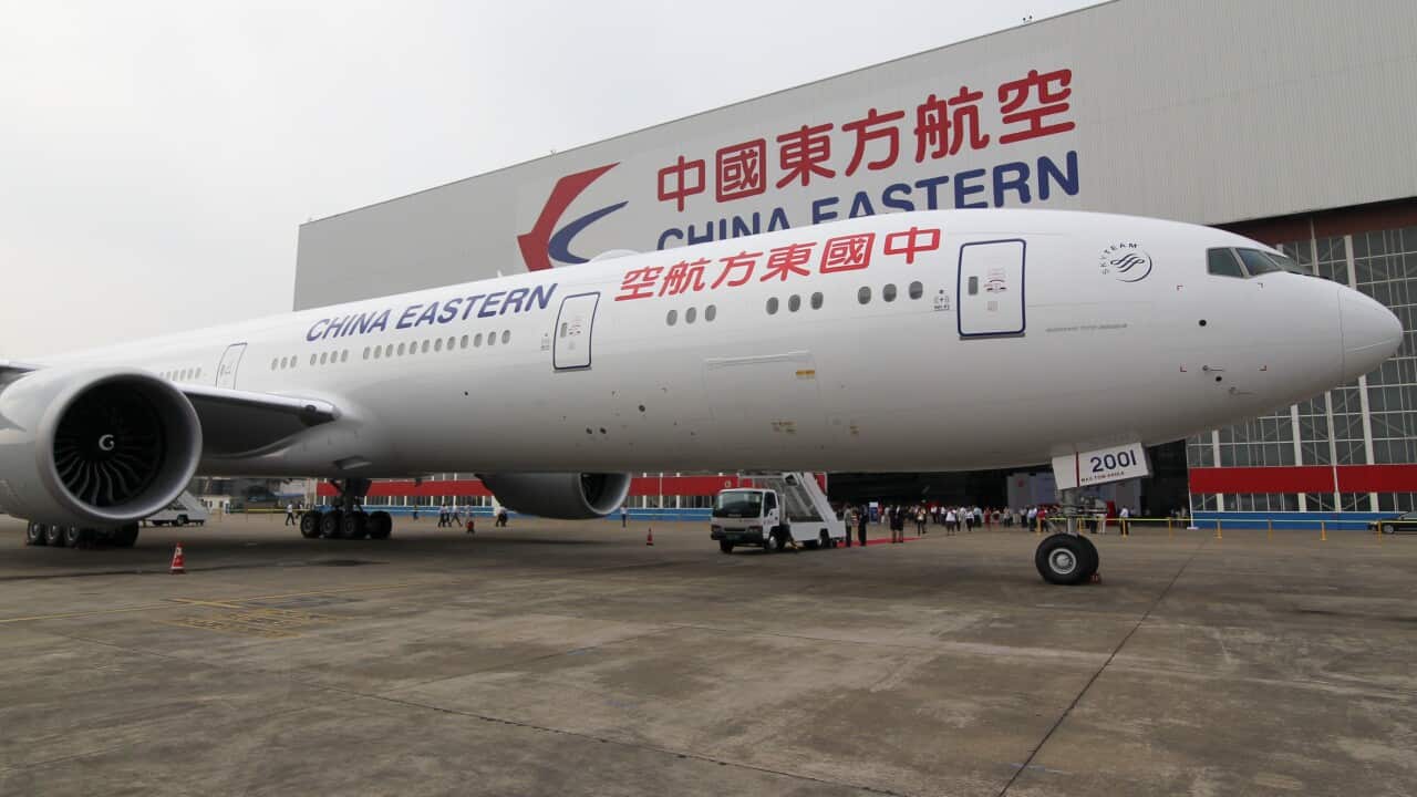 A Boeing 777-300ER jet plane of China Eastern Airlines is pictured next to a hangar at an airport in Shanghai, China, 26 September 2014. (AP/Shanghai Daily)