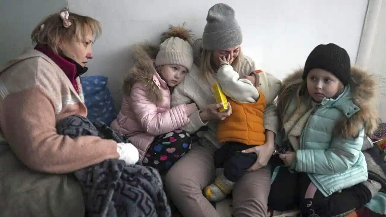 Women and children sit on the floor of a corridor in a hospital in Mariupol, eastern Ukraine Friday, 11 March, 2022.