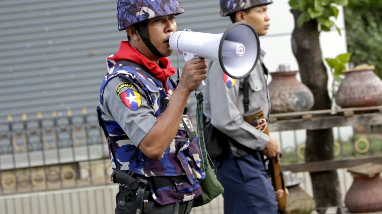 Riot police officer block the road in Mandalay, Myanmar during clashes on 4 July 2014. The violence followed allegations that two Muslim brothers who own a teashop raped a Buddhist female staff member. (EPA)