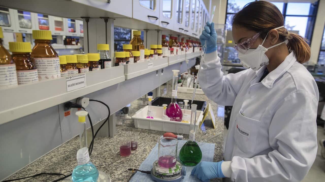 A pharmaceutical employee works on a vaccine