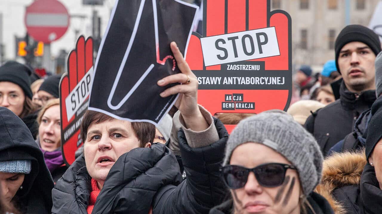 Women hold signs during a pro-choice demonstration in front of the Polish parliament in Warsaw on March 23, 2018. 