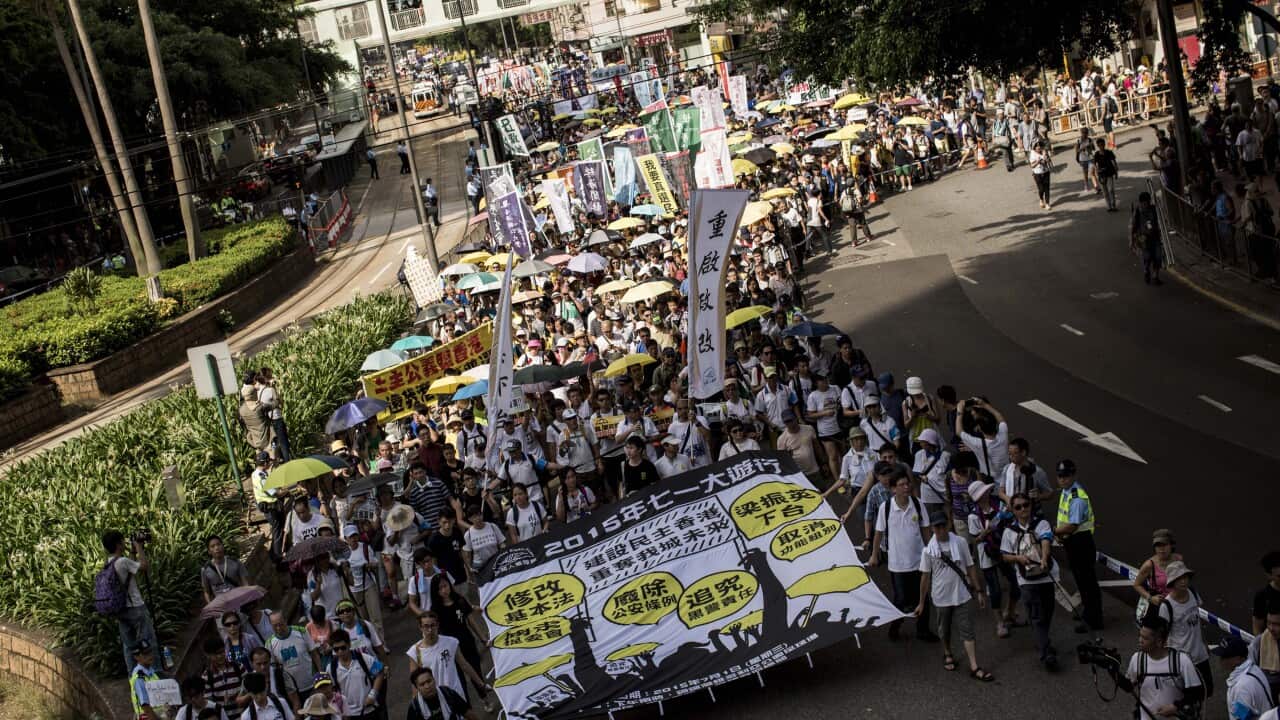 Protesters march on a street during a rally as they hold banners and shout slogans on July 1, 2015 in Hong Kong. (Anthony Kwan/Getty Images)